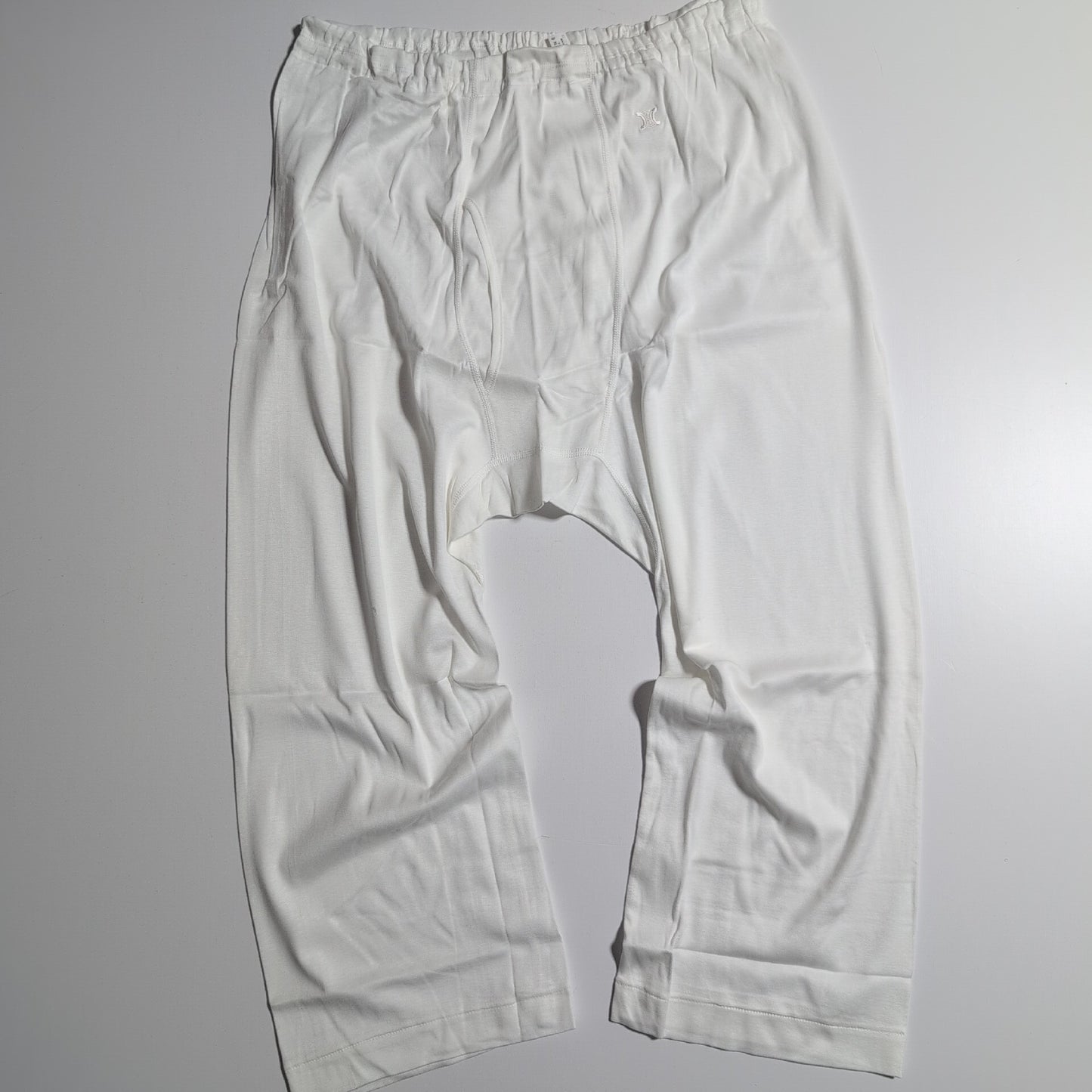 CELINE Brand new, unused cotton pants with a single Triomphe logo in white.
