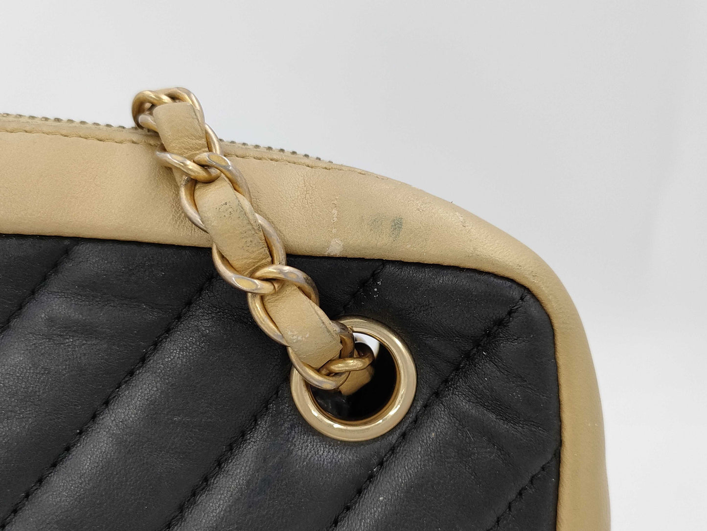 CHANEL V-stitch black and gold bag