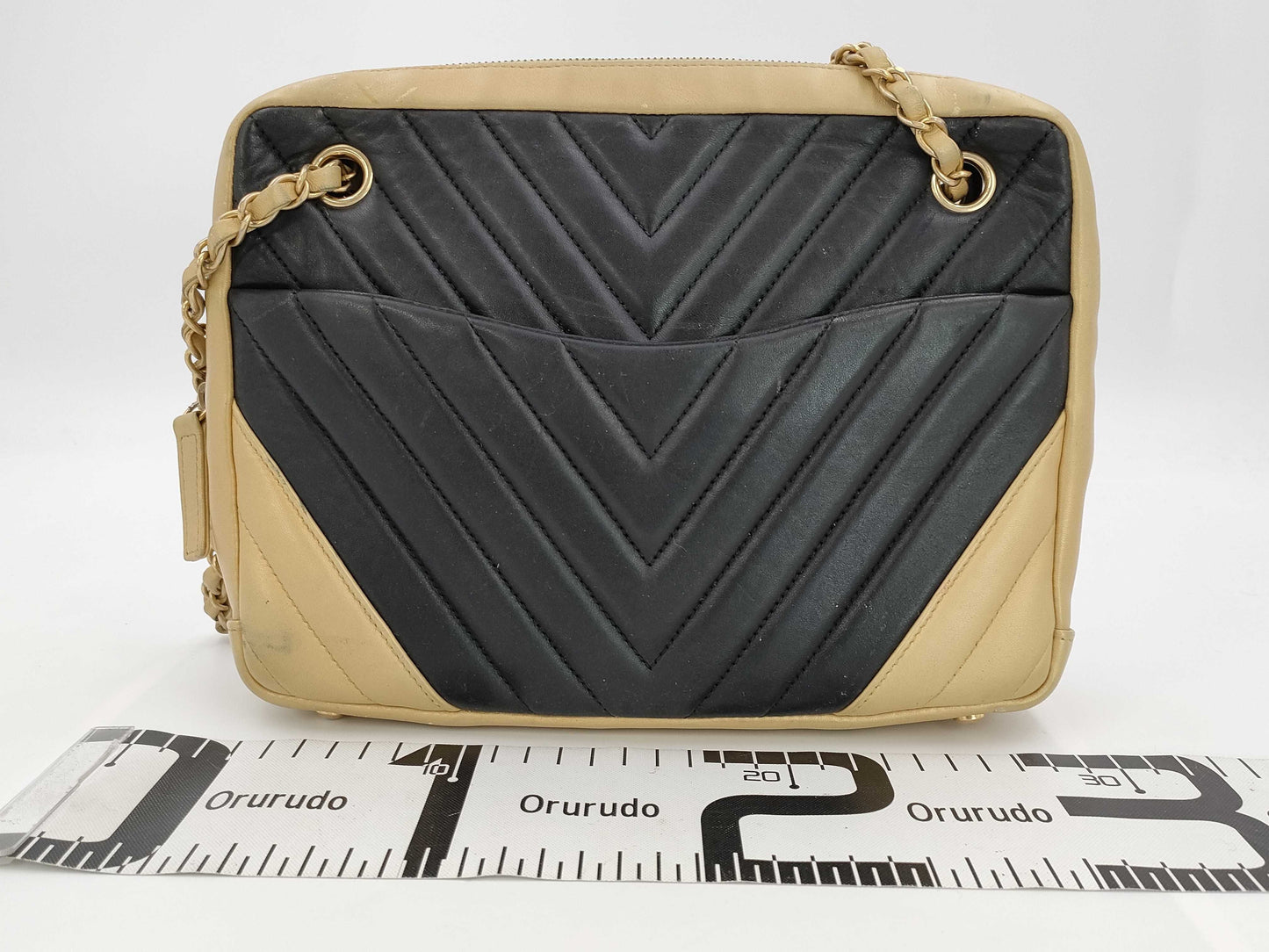 CHANEL V-stitch black and gold bag