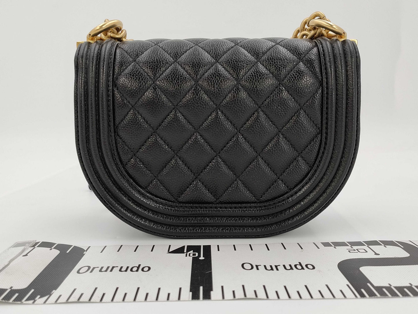 CHANEL Boy Chanel Round Caviar Leather Shoulder Bag with Gold Hardware and Chain Serial Number Plate in Black