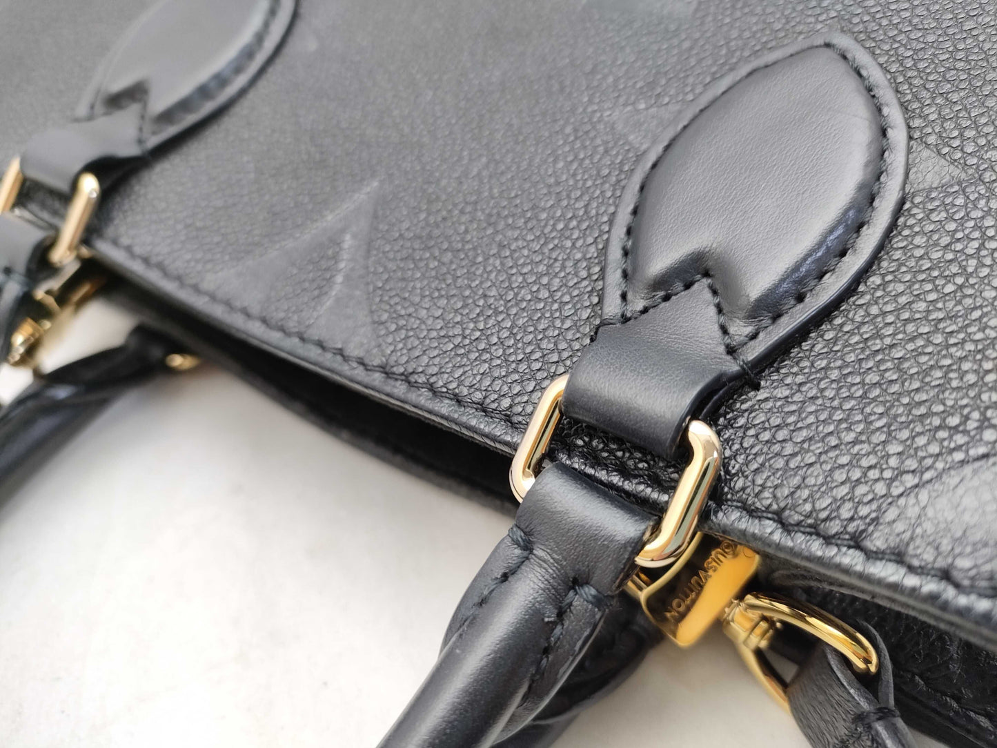 LOUIS VUITTON Monogram Empreinte Louis Vuitton On the Go PM Empreinte Handbag