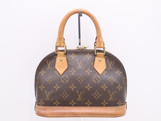 LOUIS VUITTON M53152 Monogram Alma BB Handbag with Shoulder Strap, Padlock, Two Keys, Cloche, and Dust Bag