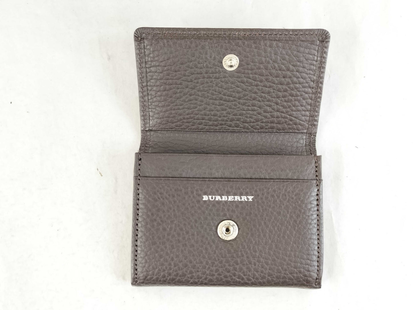 BURBERRY 18. Two Burberry clutches and a second bag