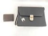 BURBERRY 18. Two Burberry clutches and a second bag