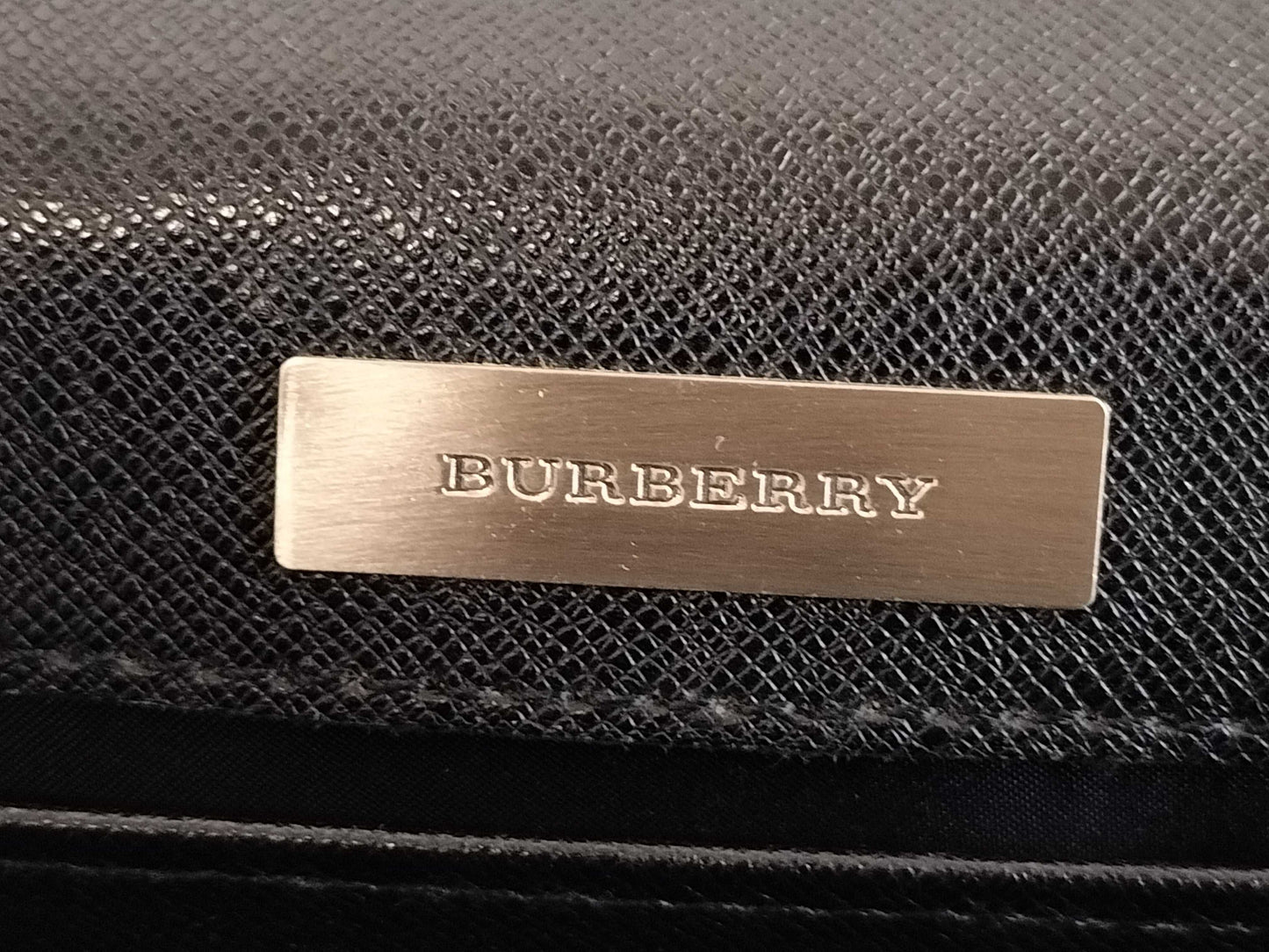 BURBERRY 18. Two Burberry clutches and a second bag