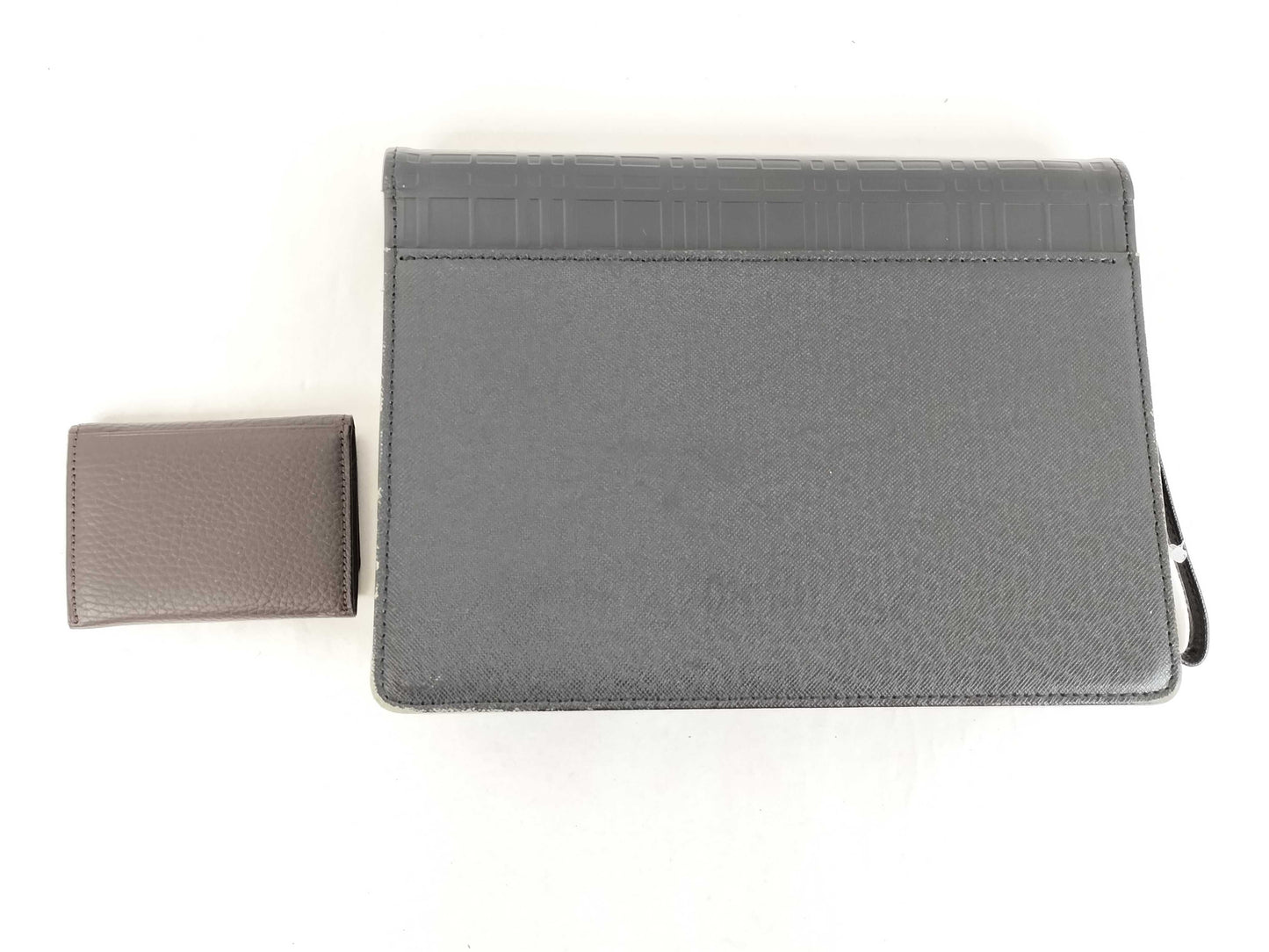 BURBERRY 18. Two Burberry clutches and a second bag
