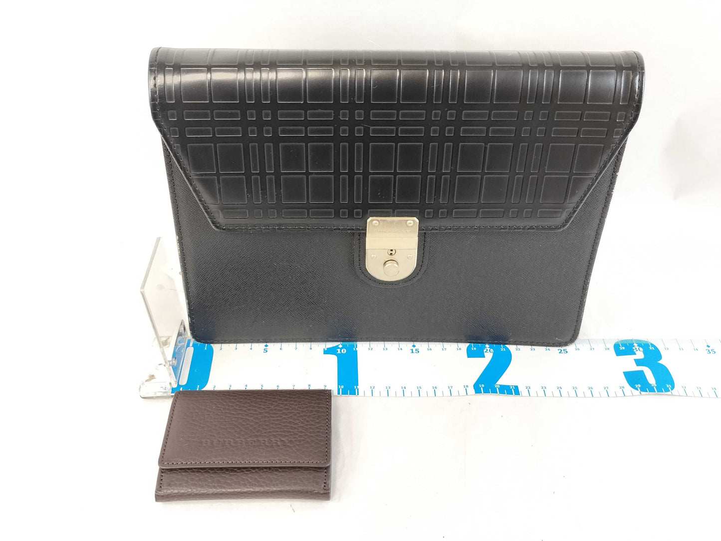 BURBERRY 18. Two Burberry clutches and a second bag