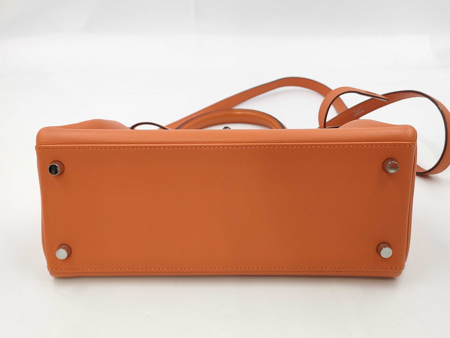 HERMES Kelly 28 handbag with silver hardware, inner stitching, orange Taurillon leather, K stamped.