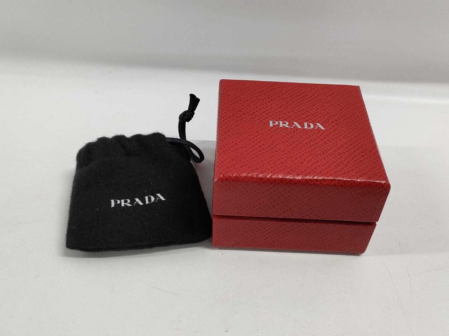 PRADA Charms and other accessories