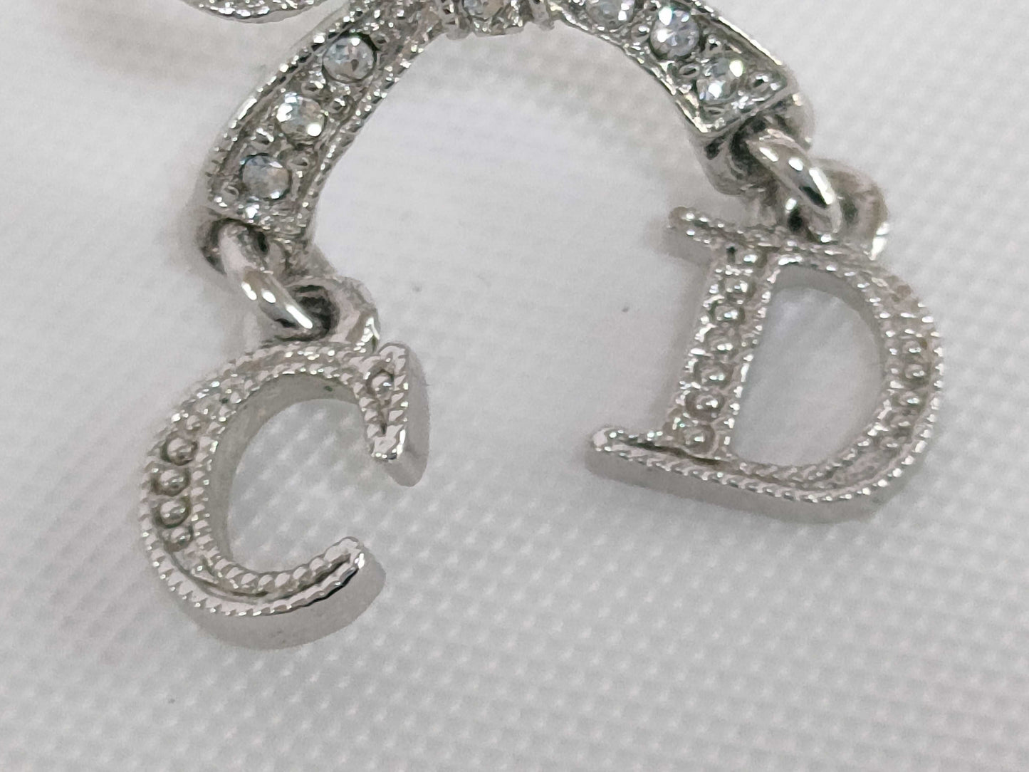 Dior CD logo ribbon rhinestone earrings