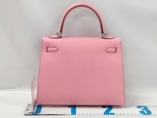 HERMES Kelly 25 handbag with rose confetti exterior, Epson logo, silver hardware, and a double stamp.