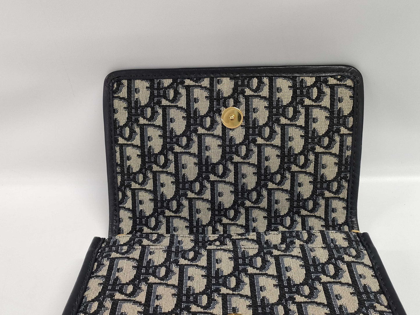 Dior Oblique 2-way waist pouch in navy, beige, and gold hardware. Canvas and leather shoulder bag.