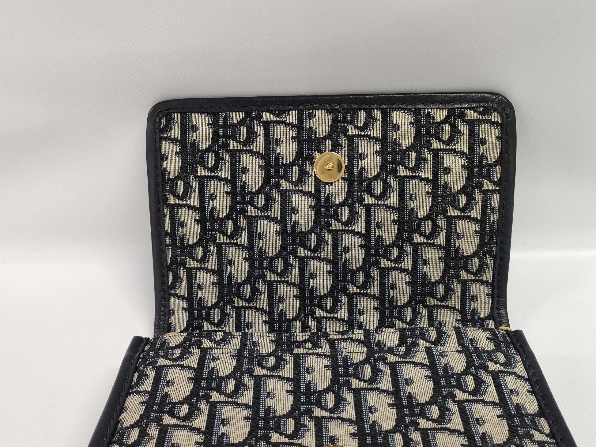 Dior Oblique 2-way waist pouch in navy, beige, and gold hardware. Canvas and leather shoulder bag.