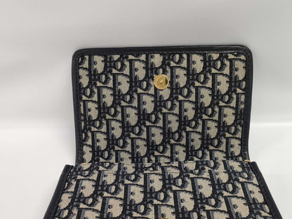 Dior Oblique 2-way waist pouch in navy, beige, and gold hardware. Canvas and leather shoulder bag.