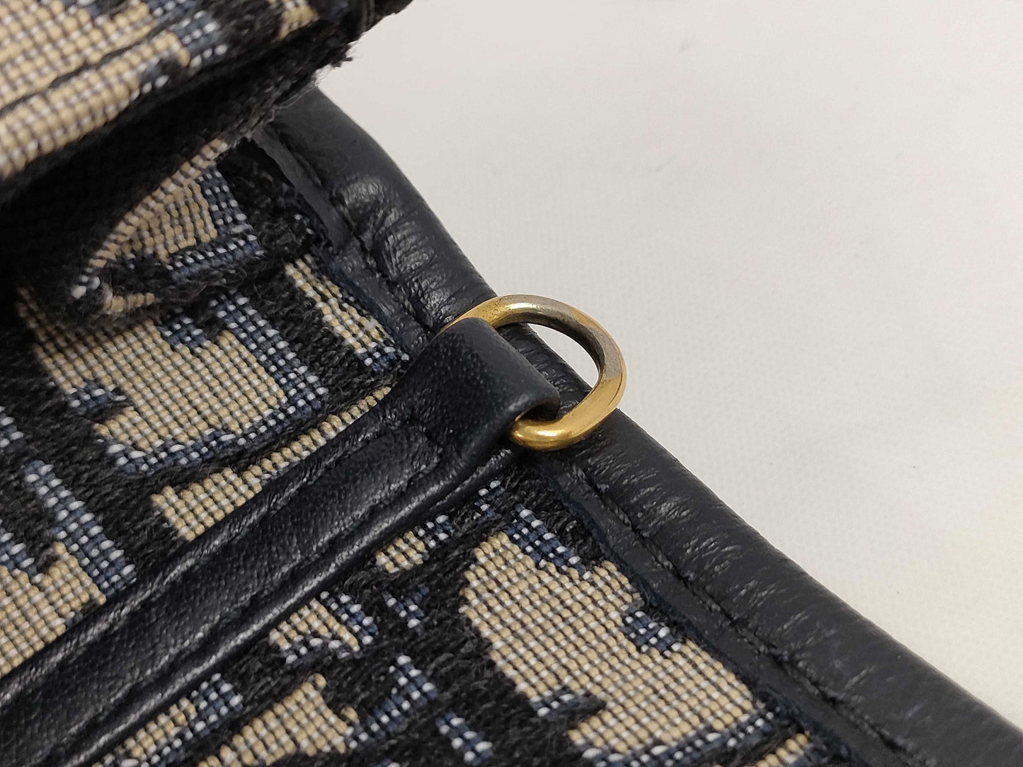 Dior Oblique 2-way waist pouch in navy, beige, and gold hardware. Canvas and leather shoulder bag.