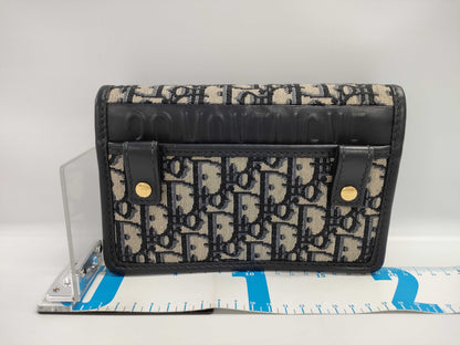 Dior Oblique 2-way waist pouch in navy, beige, and gold hardware. Canvas and leather shoulder bag.