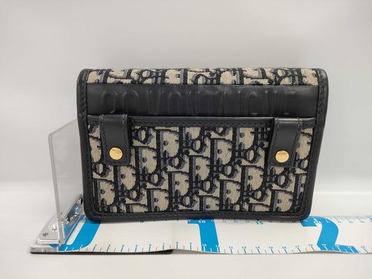 Dior Oblique 2-way waist pouch in navy, beige, and gold hardware. Canvas and leather shoulder bag.