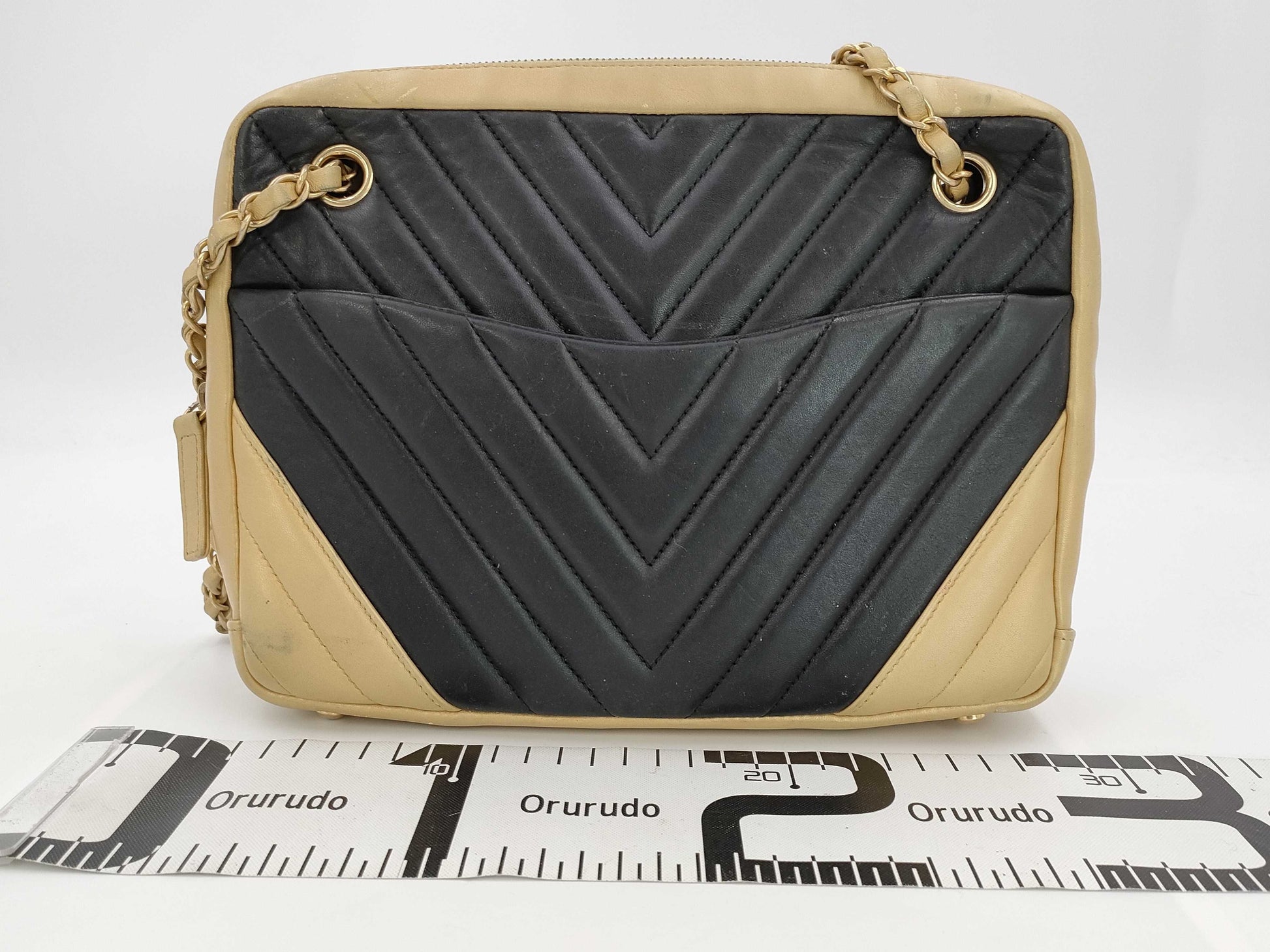 CHANEL V-stitch black and gold bag