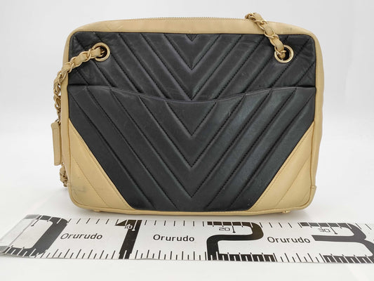 CHANEL V-stitch black and gold bag