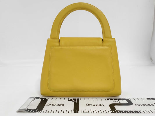 CHANEL Top Handle Lambskin Handbag with Turn Lock, Yellow