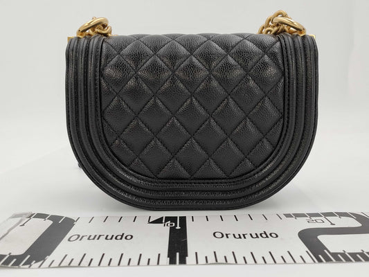 CHANEL Boy Chanel Round Caviar Leather Shoulder Bag with Gold Hardware and Chain Serial Number Plate in Black