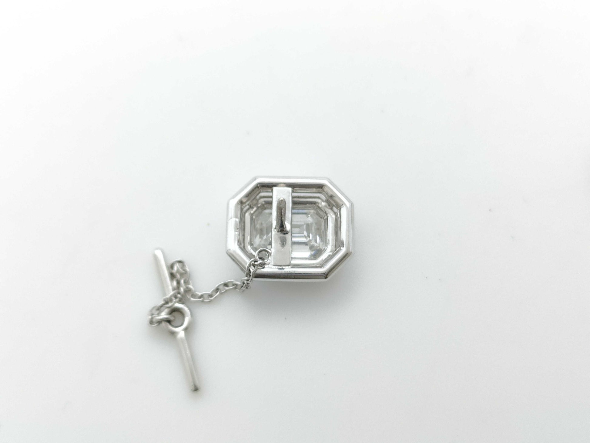 HARRY WINSTON Harry Winston PT950 Pin Brooch with 1.54ct Emerald Cut Diamond, D/VS1, and 3.6g Pavé Diamonds.