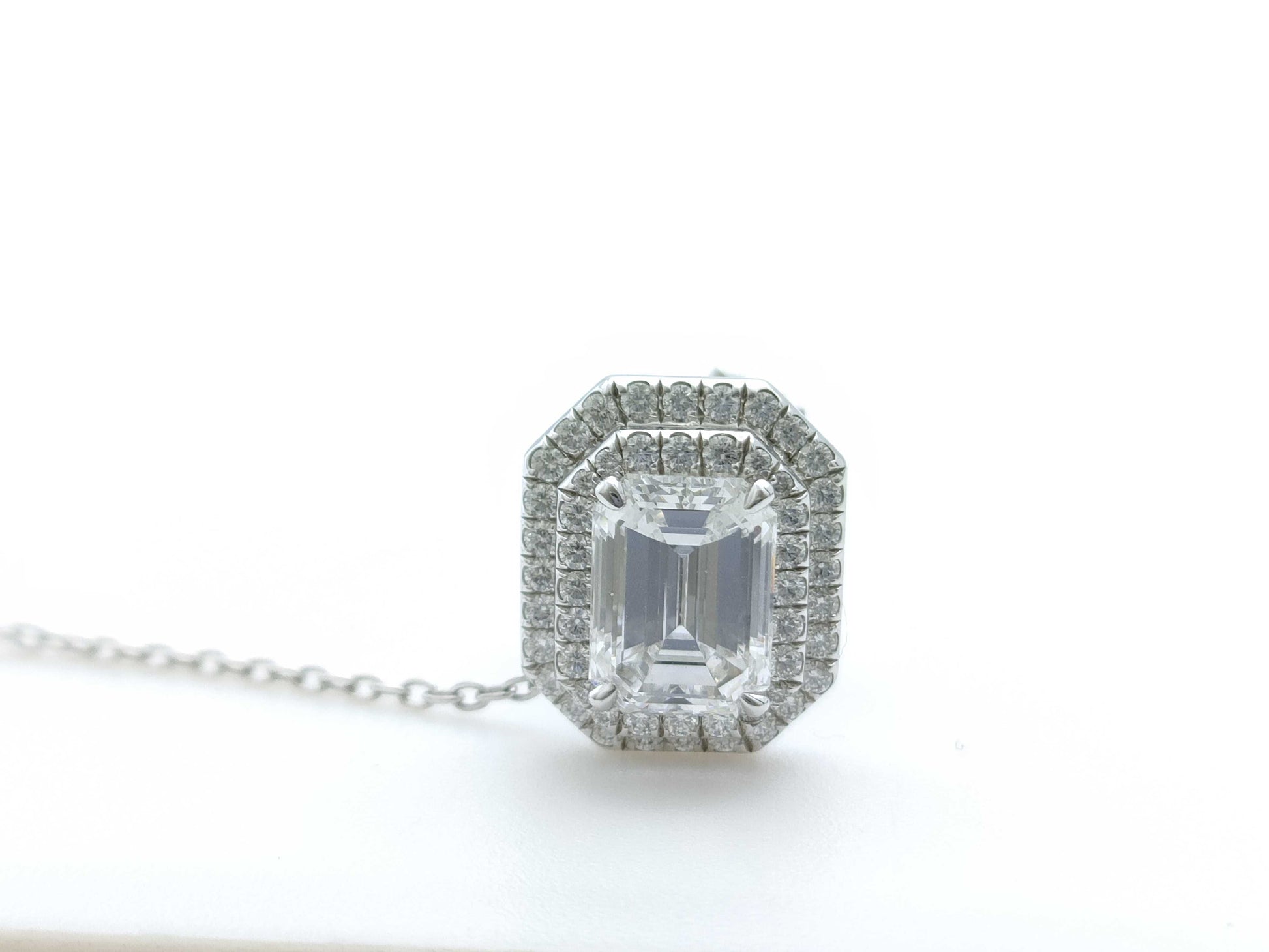 HARRY WINSTON Harry Winston PT950 Pin Brooch with 1.54ct Emerald Cut Diamond, D/VS1, and 3.6g Pavé Diamonds.