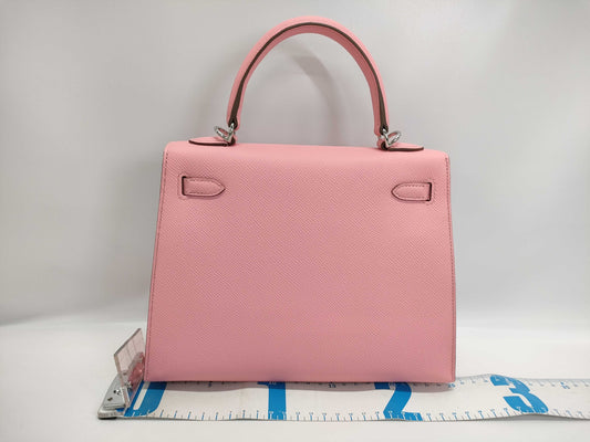HERMES Kelly 25 handbag with rose confetti on the outside, Epson logo, silver hardware, K stamp.