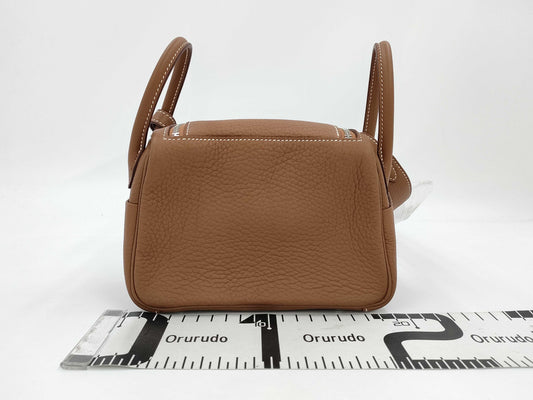 HERMES Lindy Mini Shoulder Bag in Taurillon Gold with Silver Hardware and K Stamp, with Protective Seal