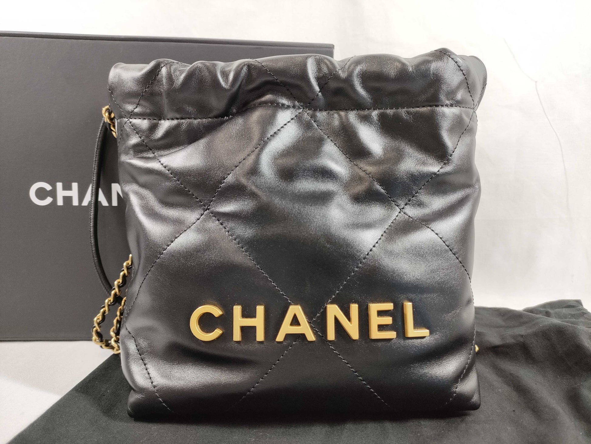 CHANEL CHANEL 22 Shiny Calfskin Chain Shoulder Bag with Gold Hardware and Serial Number Plate in Black