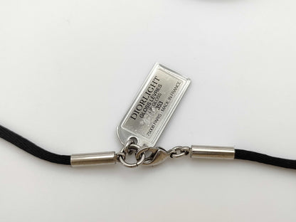 Dior logo mirror ball necklace with rhinestones and lip gloss.