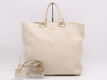 PRADA 2-way leather tote bag in white with GD hardware, shoulder strap, and name tag.