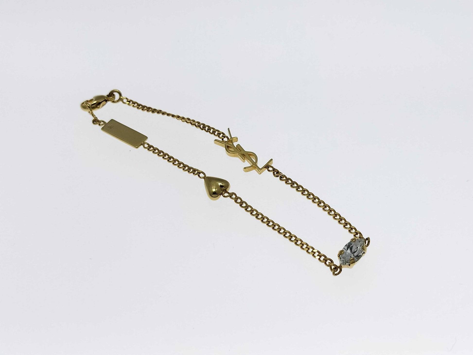 Yves Saint Laurent YSL Logo Cassandra Heart Charm Bracelet in Gold with Rhinestones. Includes Box and Dust Bag.