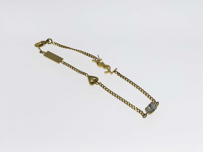 Yves Saint Laurent YSL Logo Cassandra Heart Charm Bracelet in Gold with Rhinestones. Includes Box and Dust Bag.