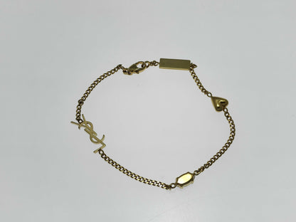 Yves Saint Laurent YSL Logo Cassandra Heart Charm Bracelet in Gold with Rhinestones. Includes Box and Dust Bag.