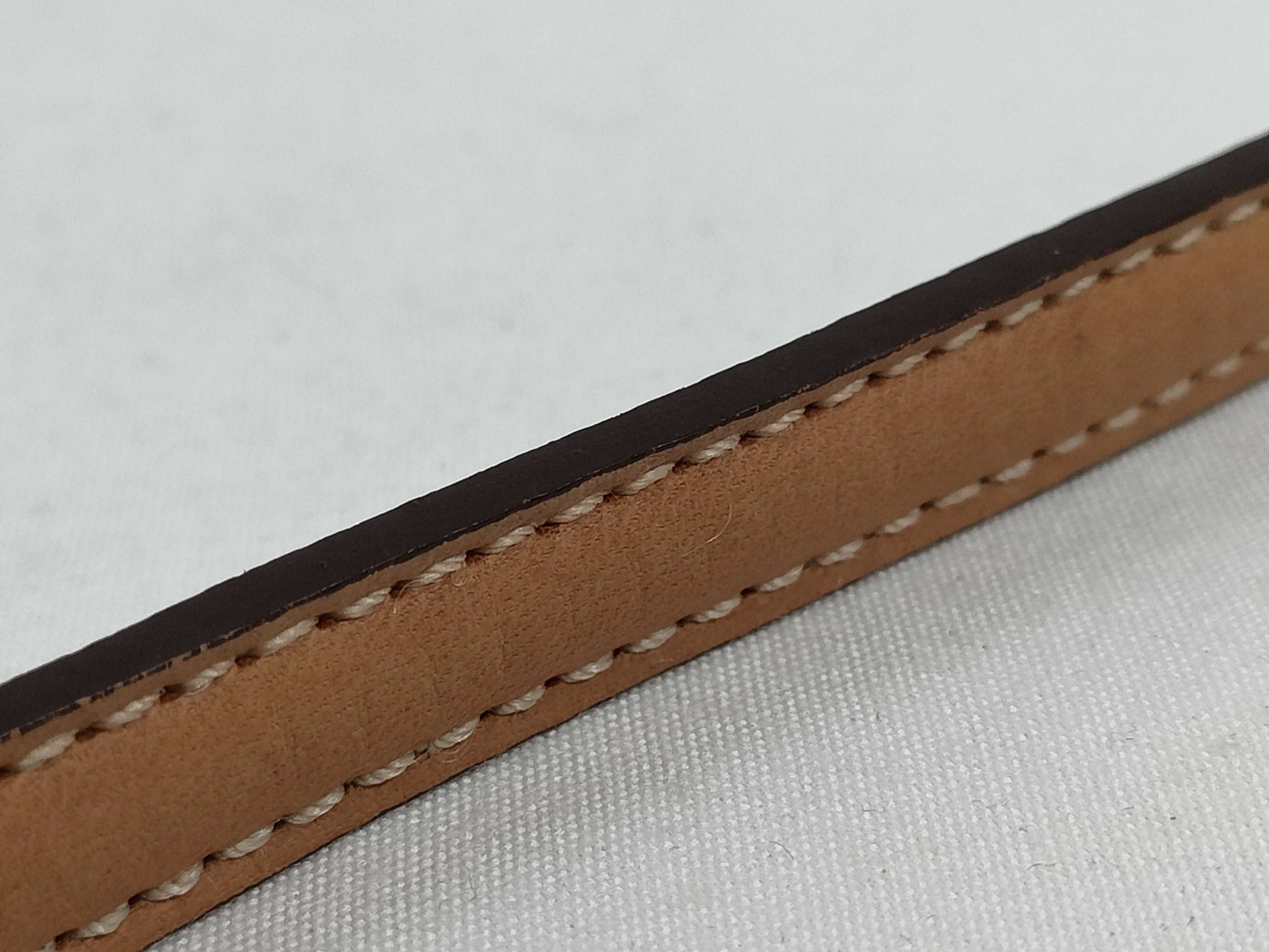 COACH Signature Stripe Patent Leather Accessory Pouch in Light Brown Canvas with Logo Charm.