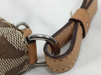 COACH Signature Stripe Patent Leather Accessory Pouch in Light Brown Canvas with Logo Charm.