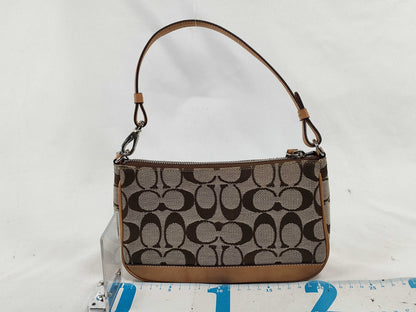 COACH Signature Stripe Patent Leather Accessory Pouch in Light Brown Canvas with Logo Charm.