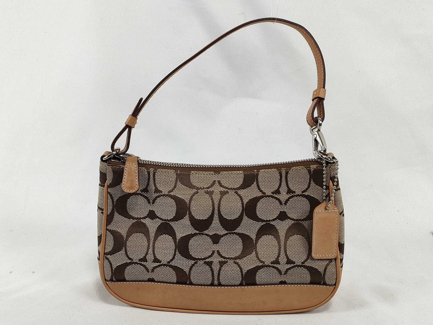 COACH Signature Stripe Patent Leather Accessory Pouch in Light Brown Canvas with Logo Charm.