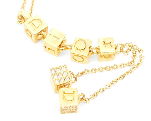 Dior Christian Dior Gold-Colored Rhinestone-Embossed Swing Logo Pendant Necklace, 8.23g