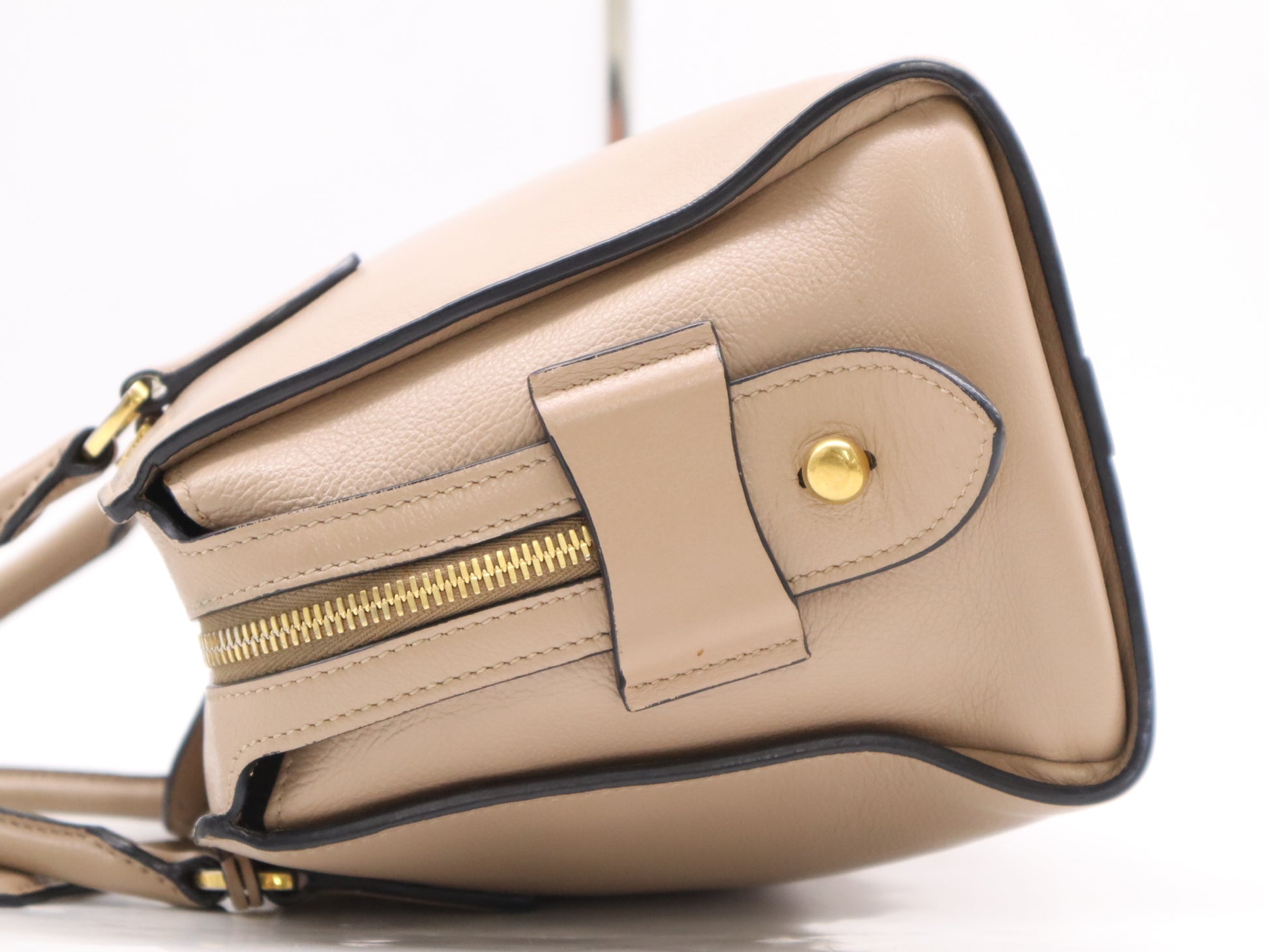 PRADA 2-way leather handbag in beige with GD hardware, shoulder strap, and clochette.