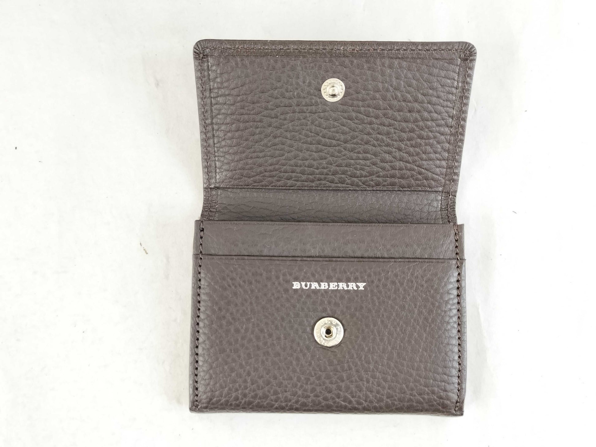 BURBERRY 18. Two Burberry clutches and a second bag