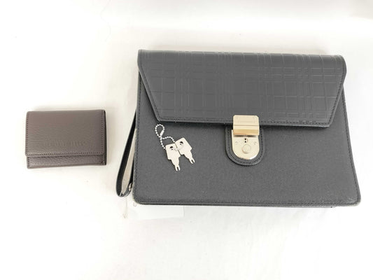 BURBERRY 18. Two Burberry clutches and a second bag
