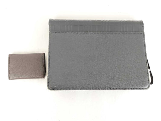 BURBERRY 18. Two Burberry clutches and a second bag